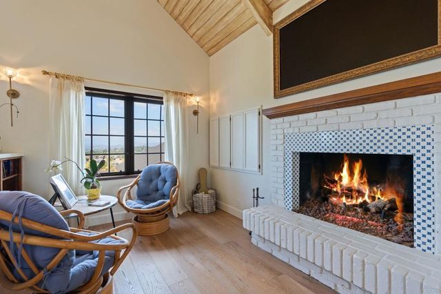 a view of a swimming pool with a yard and large trees