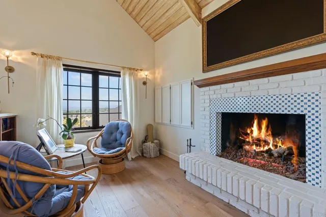 a view of a swimming pool with a yard and large trees