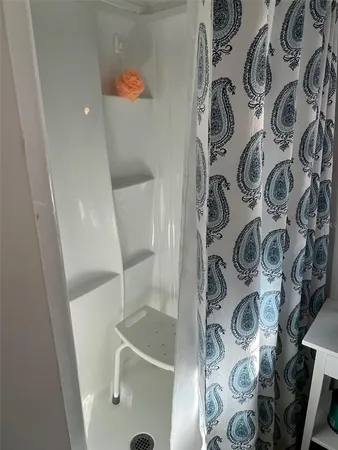 a bathroom with a window and a shower curtain