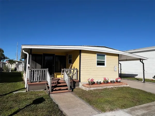a view of backyard with deck and outdoor seating