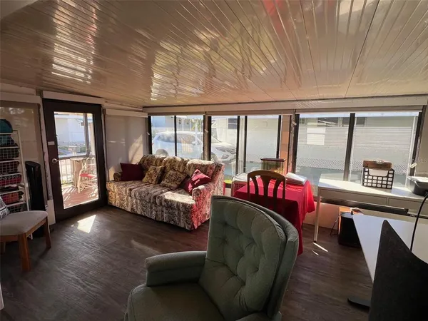 a living room with furniture and a floor to ceiling window