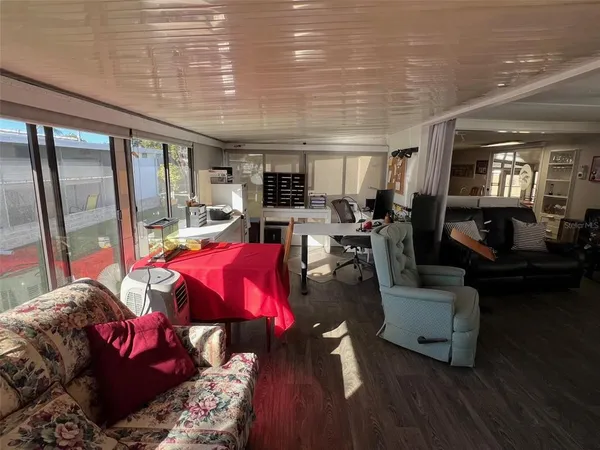 a living room with furniture and a floor to ceiling window