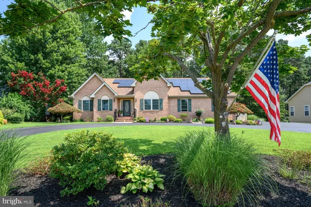 a aerial view of a house with yard and green space