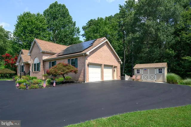 a view of a house with a yard and potted plants