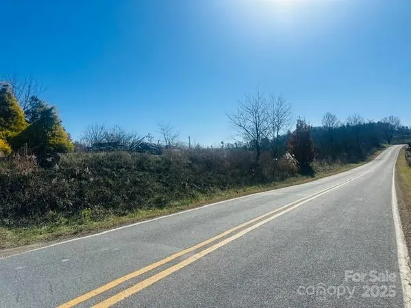 a view of a road with a building in the background