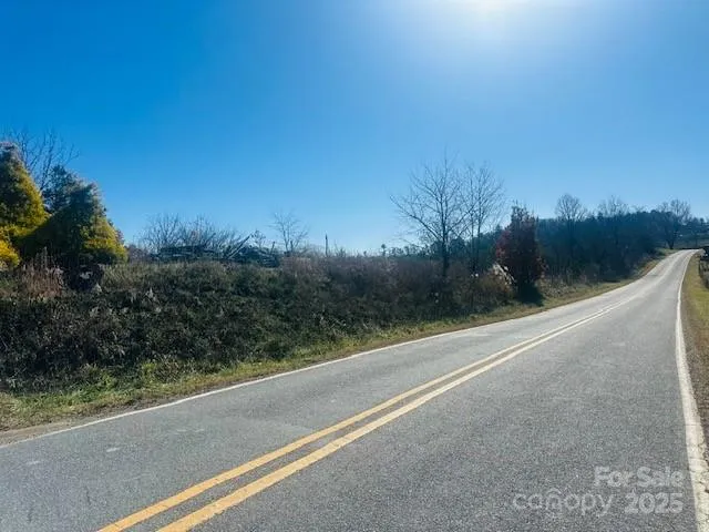 a view of a road with a building in the background