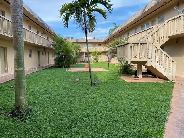 a view of a house with a yard and a slide