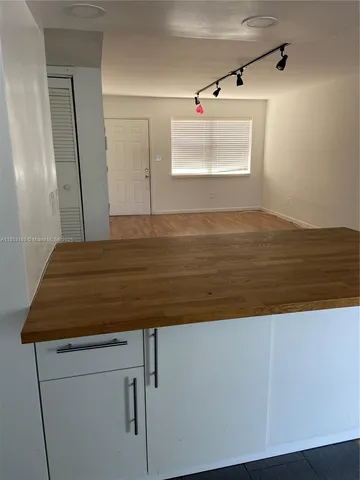 a kitchen with stainless steel appliances granite countertop a refrigerator stove and white cabinets
