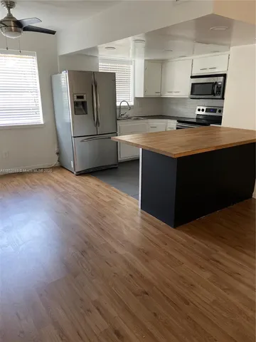a kitchen with stainless steel appliances a refrigerator and a stove