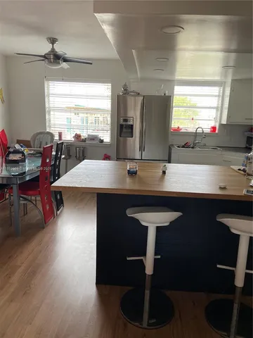a kitchen with a sink cabinets and wooden floor