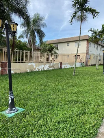 a view of a garden with a house