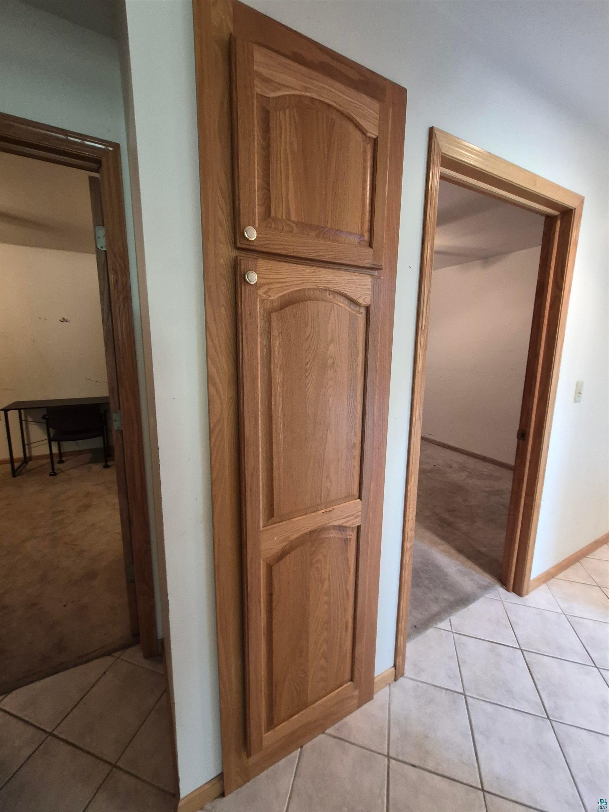 3020 East 8th Street Superior, WI 54880 - Photo 27 of 37 Built-in wood-finish cabinetry featuring raised panel doors and circular hardware