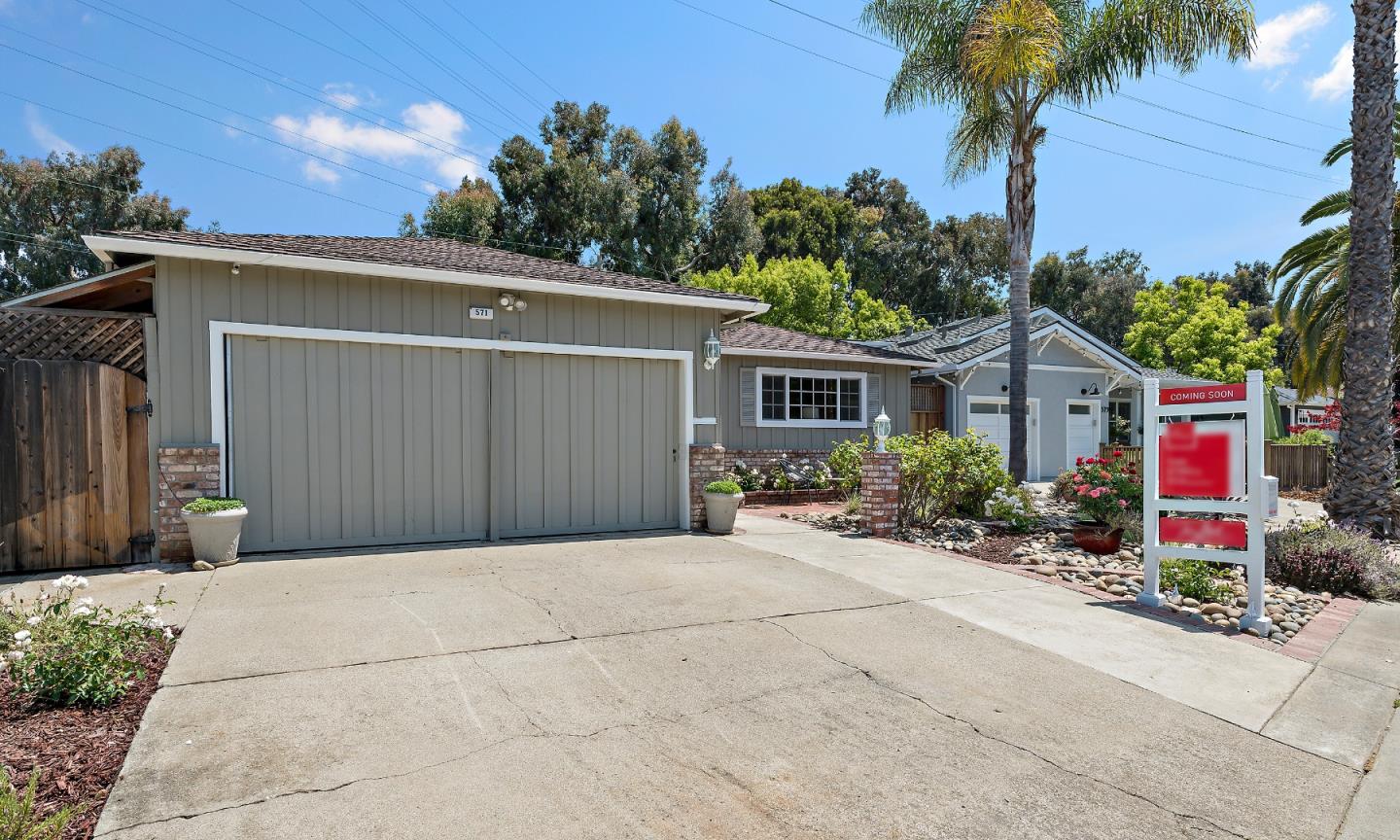 a front view of a house with a garden