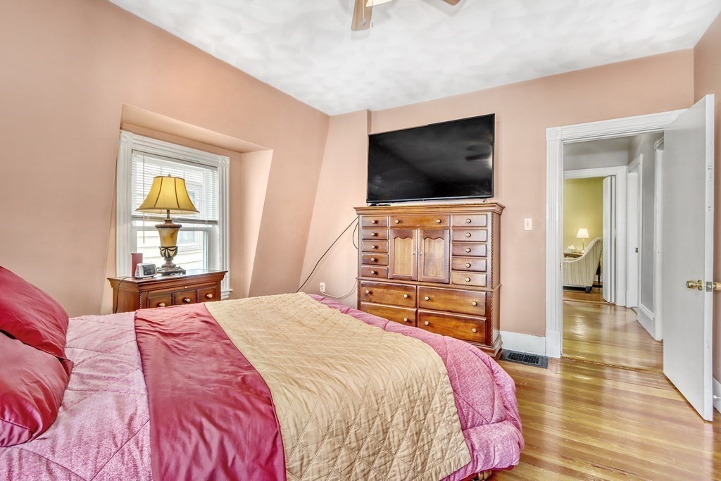 24 Baker Road Everett, MA 02149 - Photo 14 of 26 a bedroom with a bed and a flat screen tv