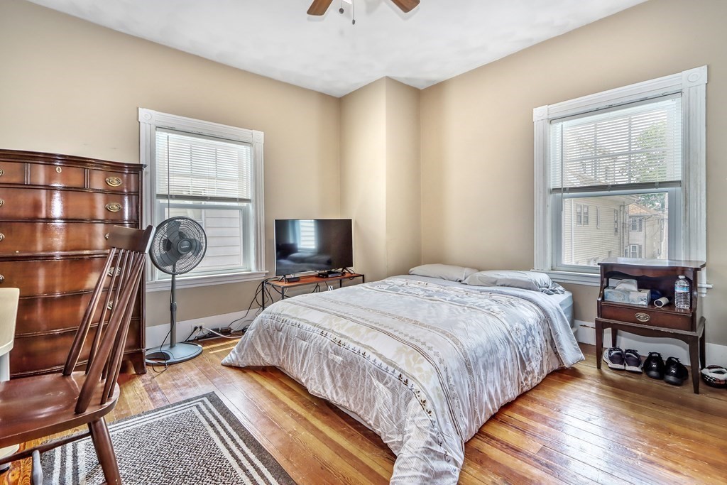 24 Baker Road Everett, MA 02149 - Photo 15 of 26 a bedroom with a bed a dresser and next to a window