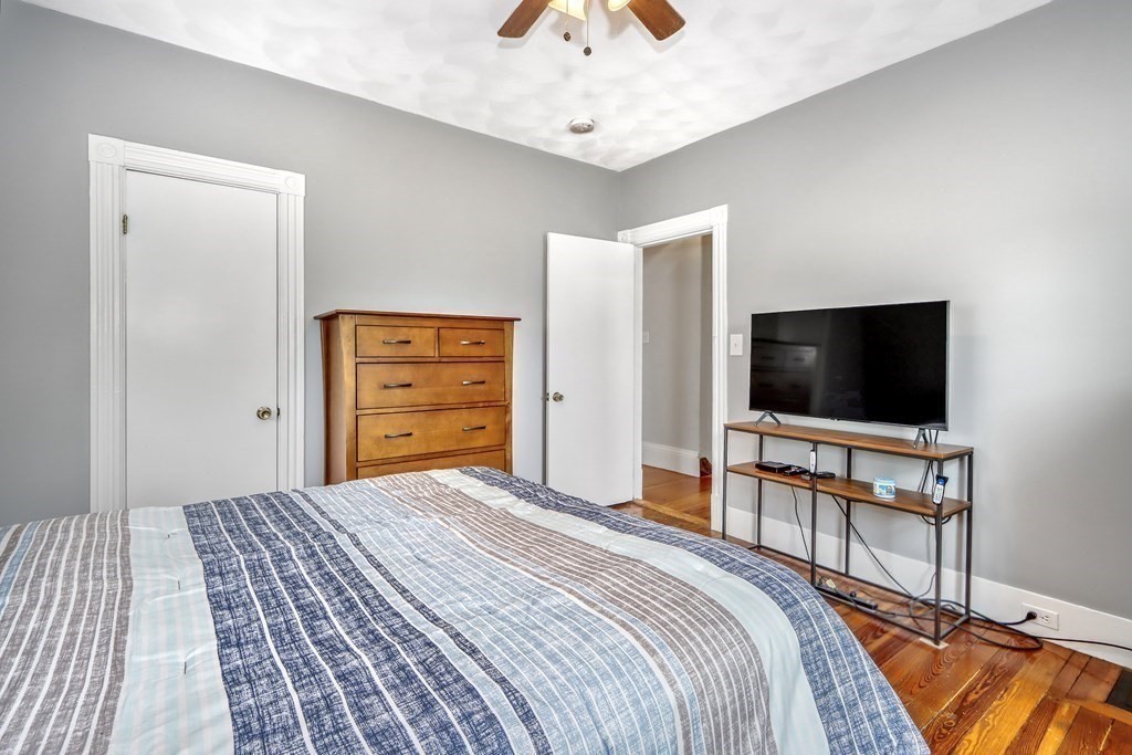 24 Baker Road Everett, MA 02149 - Photo 18 of 26 a bedroom with a bed and a flat screen tv