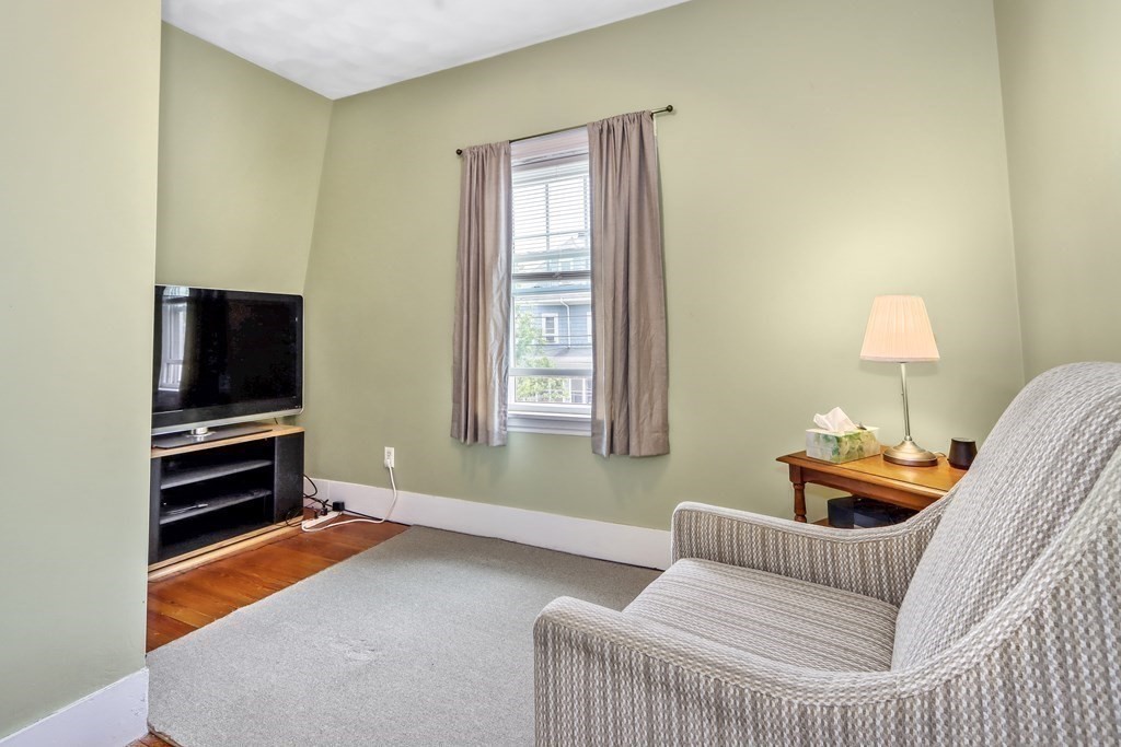 24 Baker Road Everett, MA 02149 - Photo 19 of 26 a living room with furniture and a flat screen tv