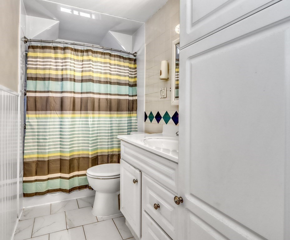 24 Baker Road Everett, MA 02149 - Photo 20 of 26 a bathroom with a sink toilet and shower