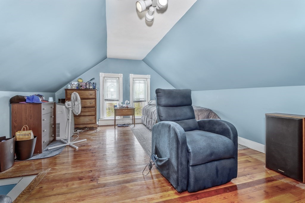 24 Baker Road Everett, MA 02149 - Photo 21 of 26 a living room with furniture and a chandelier