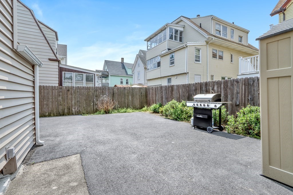 24 Baker Road Everett, MA 02149 - Photo 24 of 26 a view of a house with a yard and plants