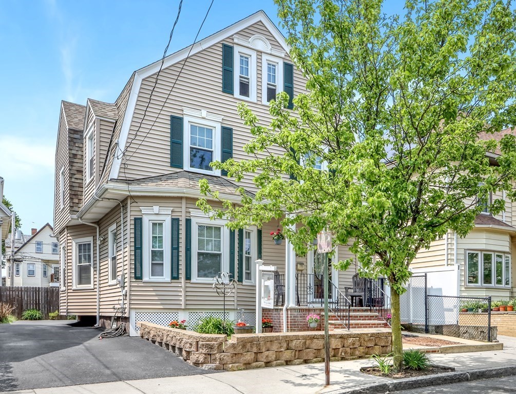 24 Baker Road Everett, MA 02149 - Photo 3 of 26 a front view of a house with a garden