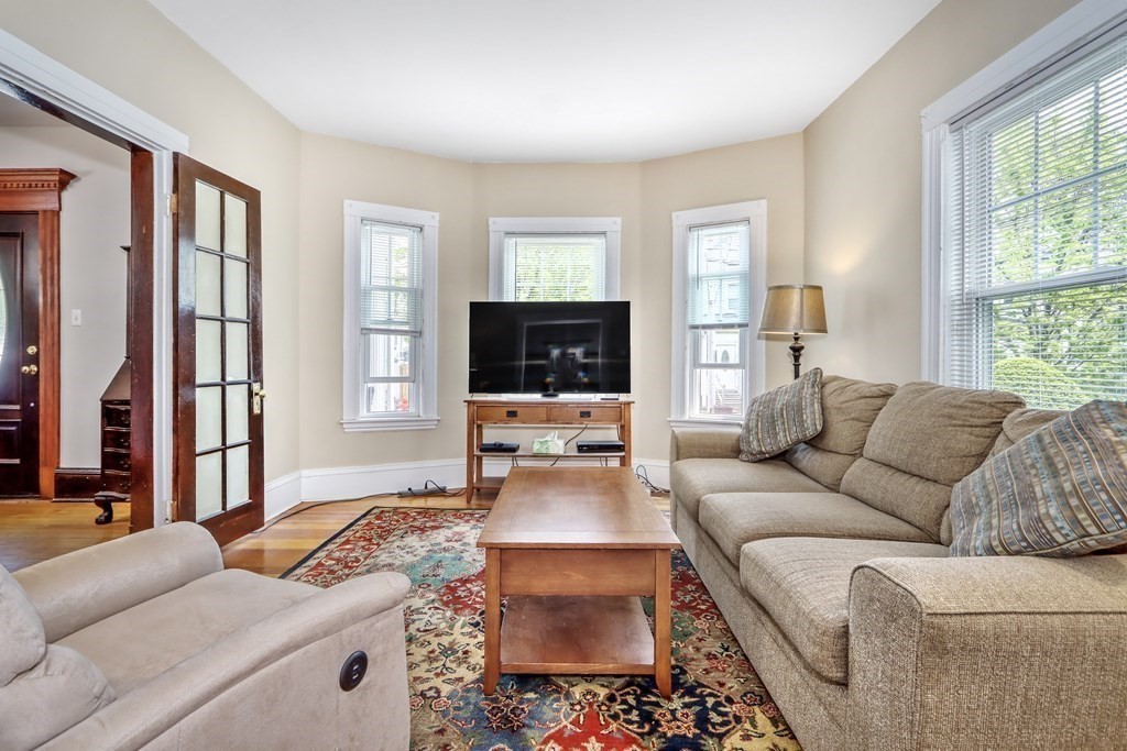 24 Baker Road Everett, MA 02149 - Photo 6 of 26 a living room with furniture and a flat screen tv