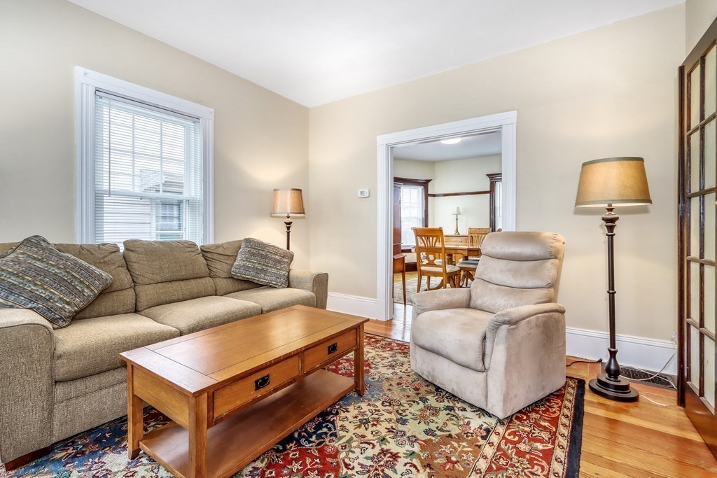 24 Baker Road Everett, MA 02149 - Photo 7 of 26 a living room with furniture and a lamp