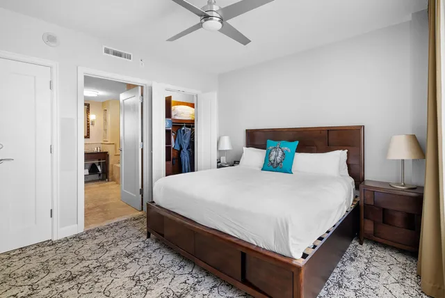 a large bed sitting in a bedroom and a table