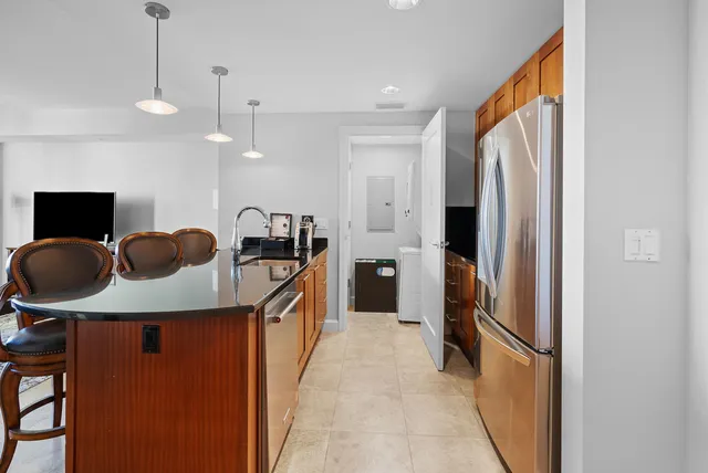 a kitchen with stainless steel appliances granite countertop a refrigerator and a stove top oven