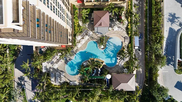 an aerial view of residential house with outdoor space and trees all around