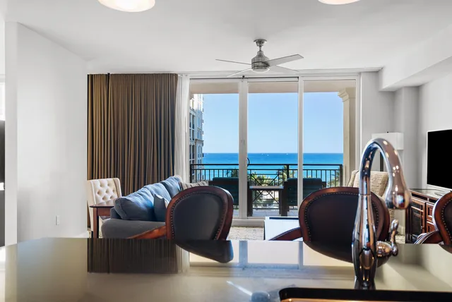 a living room with furniture and floor to ceiling window