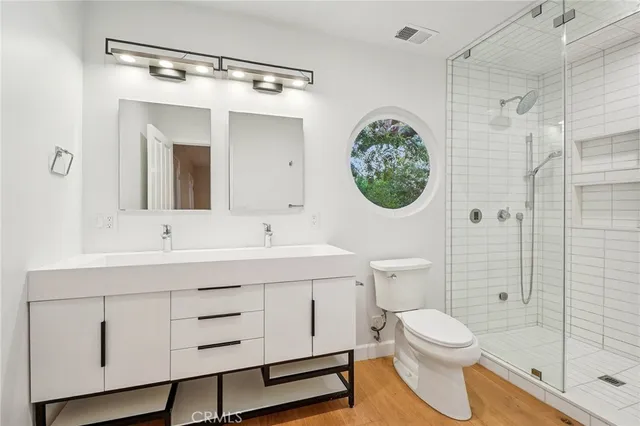 a bathroom with a toilet and a shower