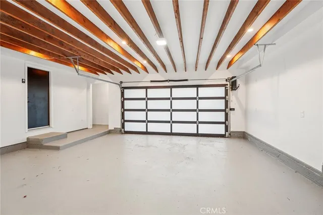 a view of a room with wooden floor and windows