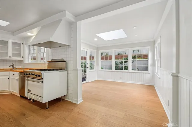 a view of kitchen with stainless steel appliances granite countertop a stove and a refrigerator