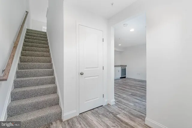 a view of a hallway with wooden floor and entryway