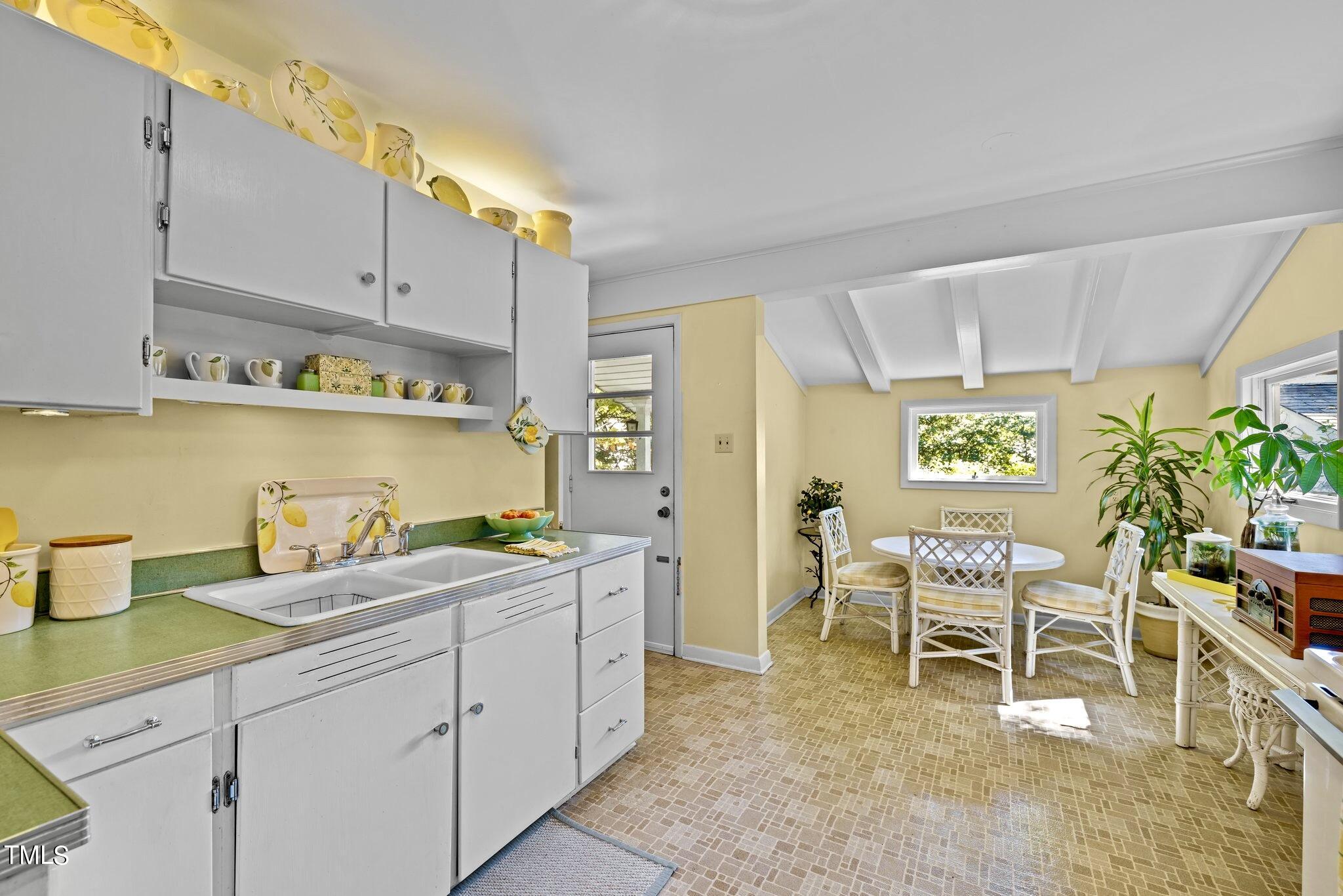 1510 Ridge Road Raleigh, NC 27607 - Photo 23 of 55 a kitchen with a sink and cabinets