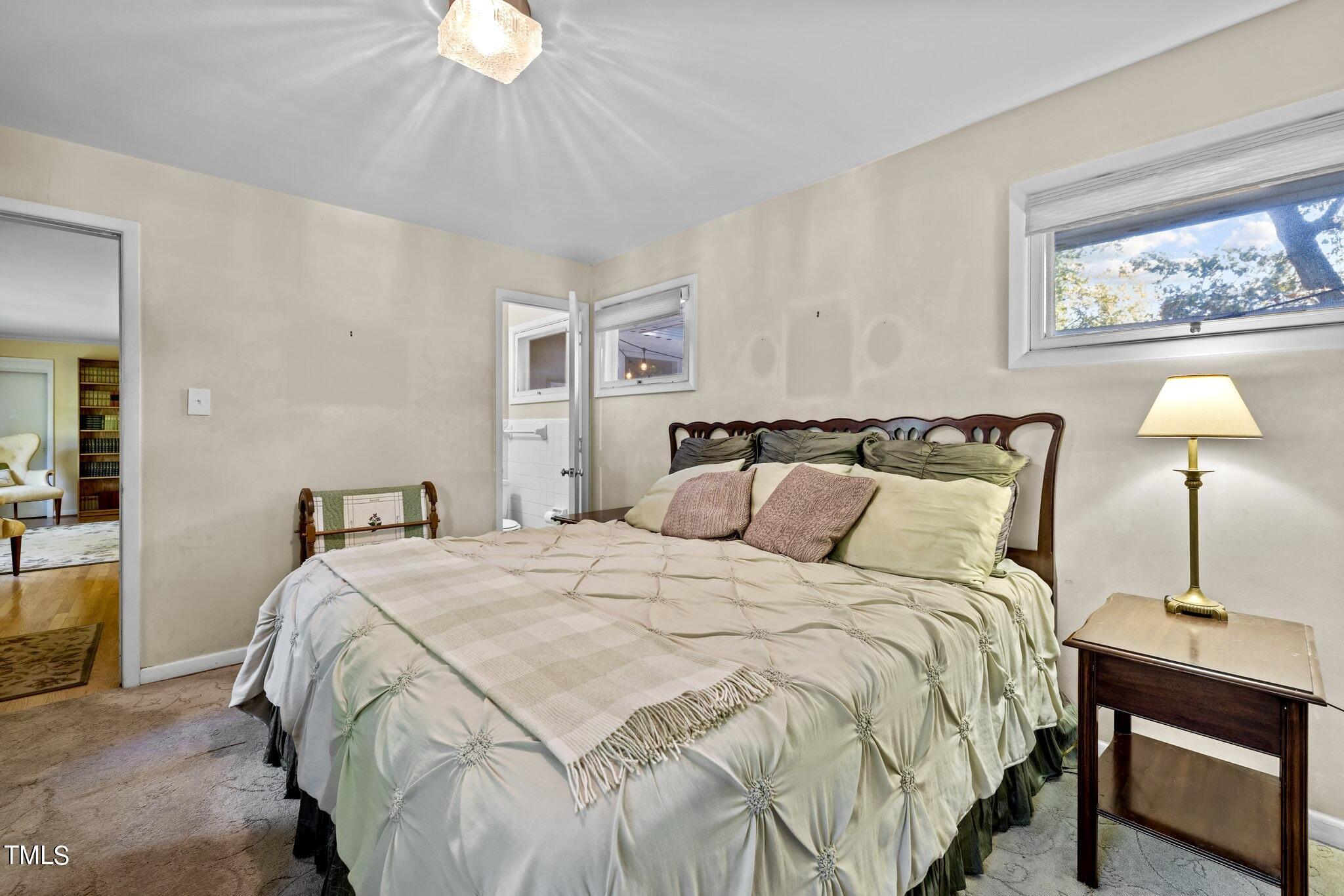 1510 Ridge Road Raleigh, NC 27607 - Photo 30 of 55 a bedroom with a bed and a chandelier