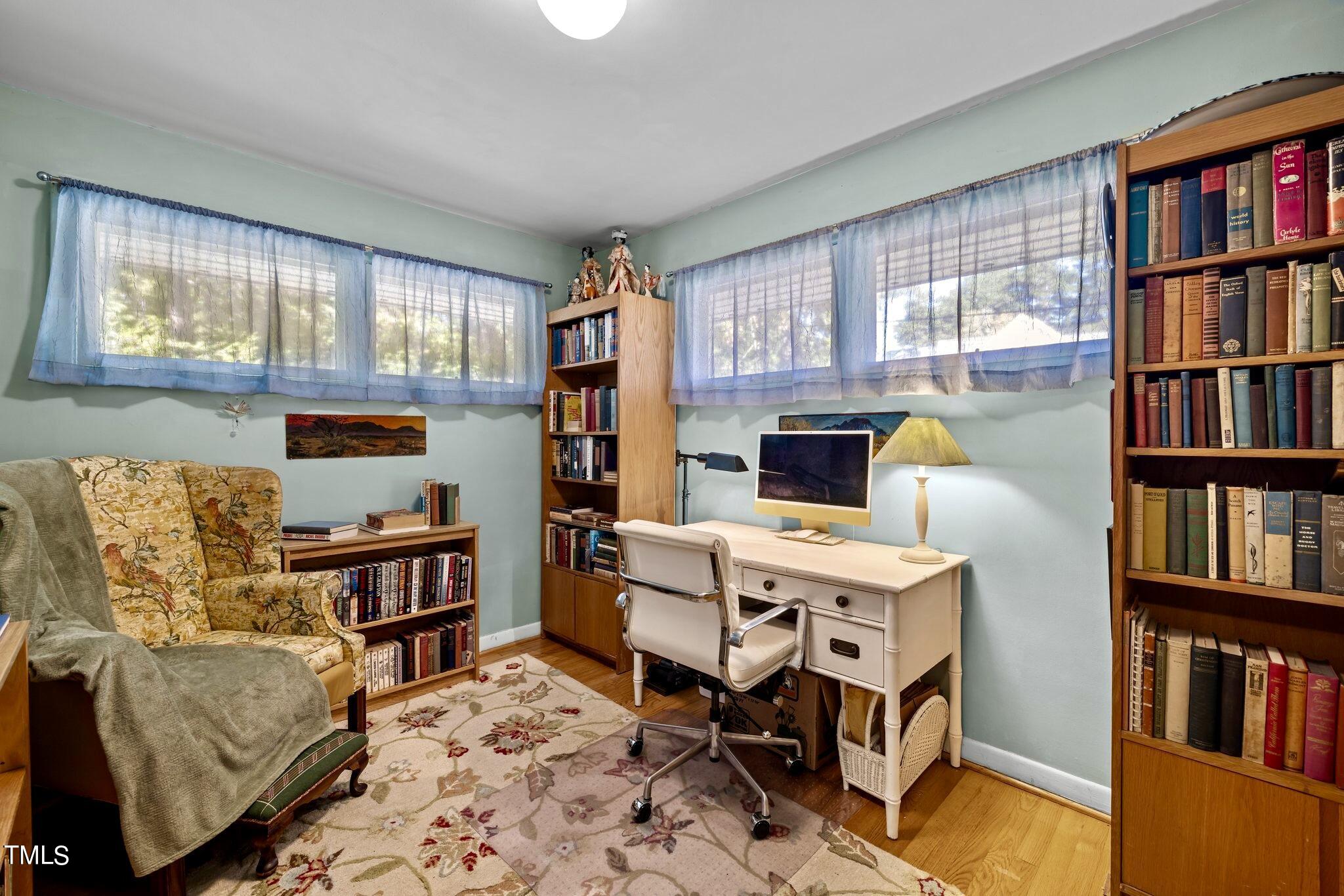 1510 Ridge Road Raleigh, NC 27607 - Photo 33 of 55 a view of a workspace with furniture and a book shelf