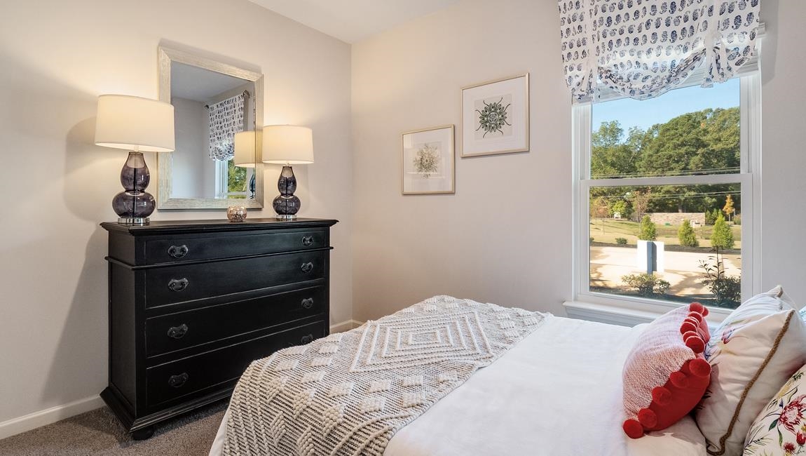 430 Windemere Loop Oakland, TN 38060 - Photo 21 of 28 a bedroom with a bed and a dresser next to a window