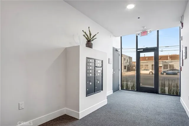 a view of an empty room with window and cabinet