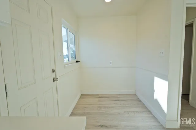 a view of a room with wooden floor and windows