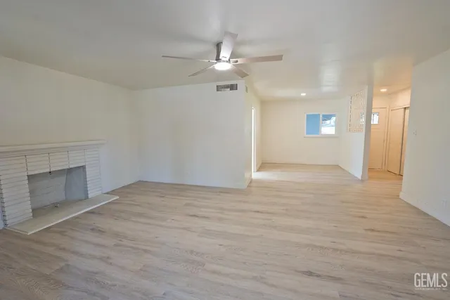 wooden floor in an empty room with a fireplace