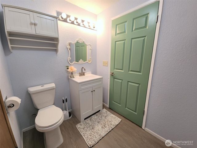 a bathroom with a toilet sink and mirror