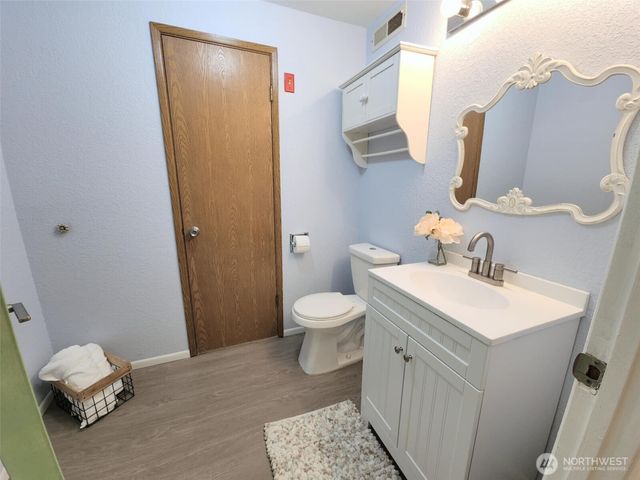 a bathroom with a sink a toilet and a mirror