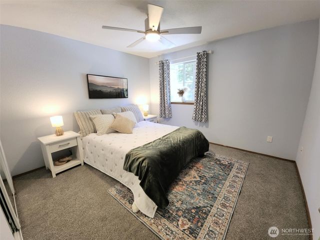 a bedroom with a bed and a tv