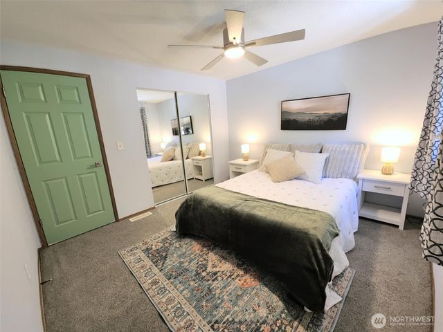 a bedroom with a bed and a mirror