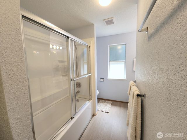 a bathroom with a tub and shower