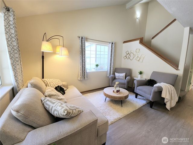 a living room with furniture and a large mirror