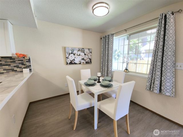 a dining room with furniture and window