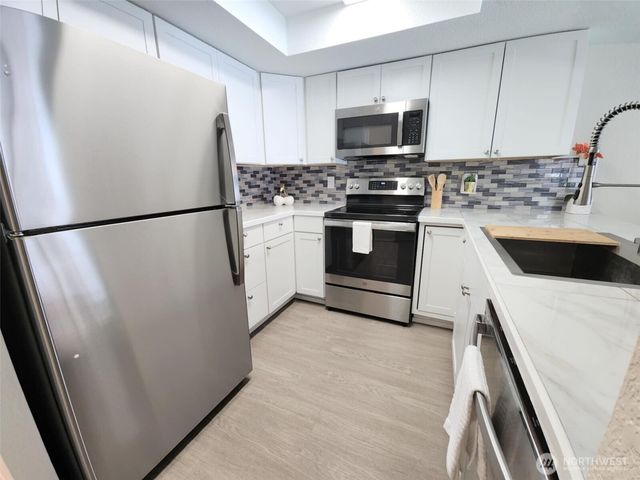 a white refrigerator freezer sitting in a kitchen
